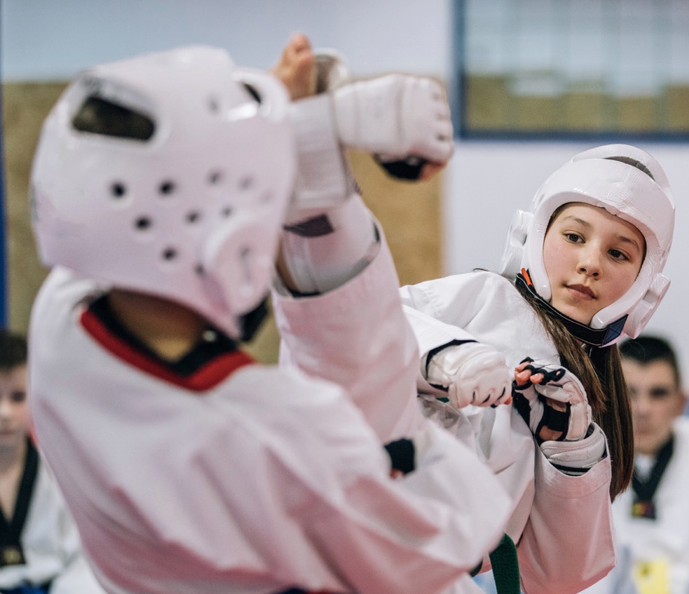 Taekwondo students sparring during competition training